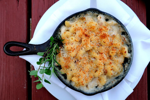 Mac and cheese in a cast iron skillet, on white napkin, tasty food.