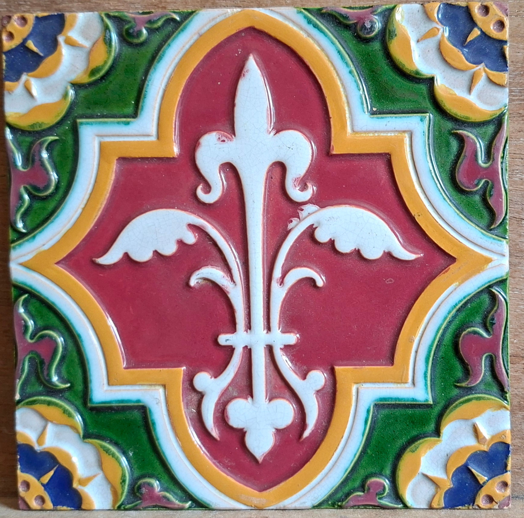 Richly enamelled polychrome fleur de lys