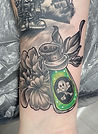 Black and Grey spooky poison and flower tattoo designed and tattooed by Ocala florida tattoo artist Aubrey at The Tattoo Gallery of Ocala in Ocala Florida