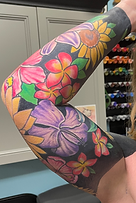 HEALED various florals with solid blackout backgound tattoo designed and tattooed by Gregg at The tattoo Gallery of Ocala, LLC