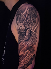 Black and grey realism eagle mountain and forest scene tattoo designed and tattooed by Belleview FL tattoo artist Randy at Stranger Flowers Yet Tattoo