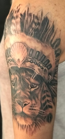 Black and grey realism lion tattoo designed and tattooed by Gregg