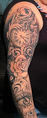 Custom black and grey filigree, floral, clock, and eye full arm sleeve tattoo created by Ocala Florida tattoo artist Gregg at The Tattoo Gallery of Ocala