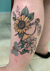 Harry Potter sunflower and potion bottle designed and tattooed by ocala florida tattoo artist Gregg at The Tattoo Gallery of Ocala, LLC