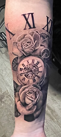 Black and grey realism tattoo. Rose, clock, and roman numerals tattoo designed and tattooed by ocala florida tattoo artist Gregg at The tattoo Gallery of Ocala, LLC