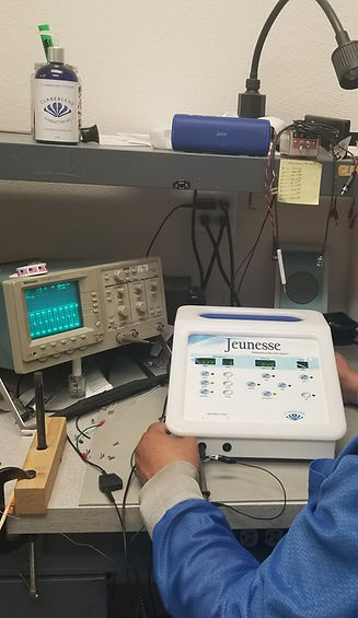 A person working on a Jeunesse Pro microcurrent system