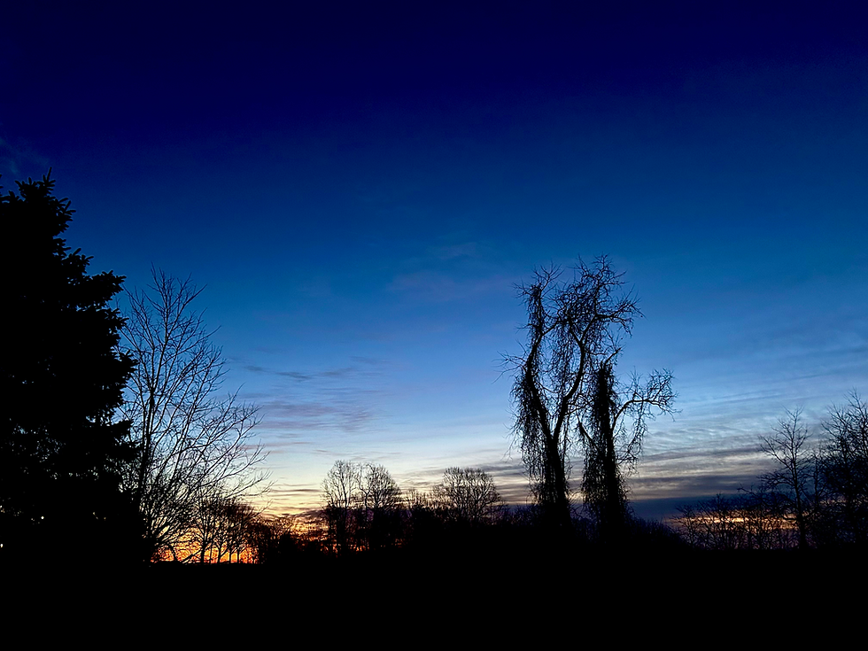 “Blue hour… and a thin orange seam on the horizon—promise, before the storm.”