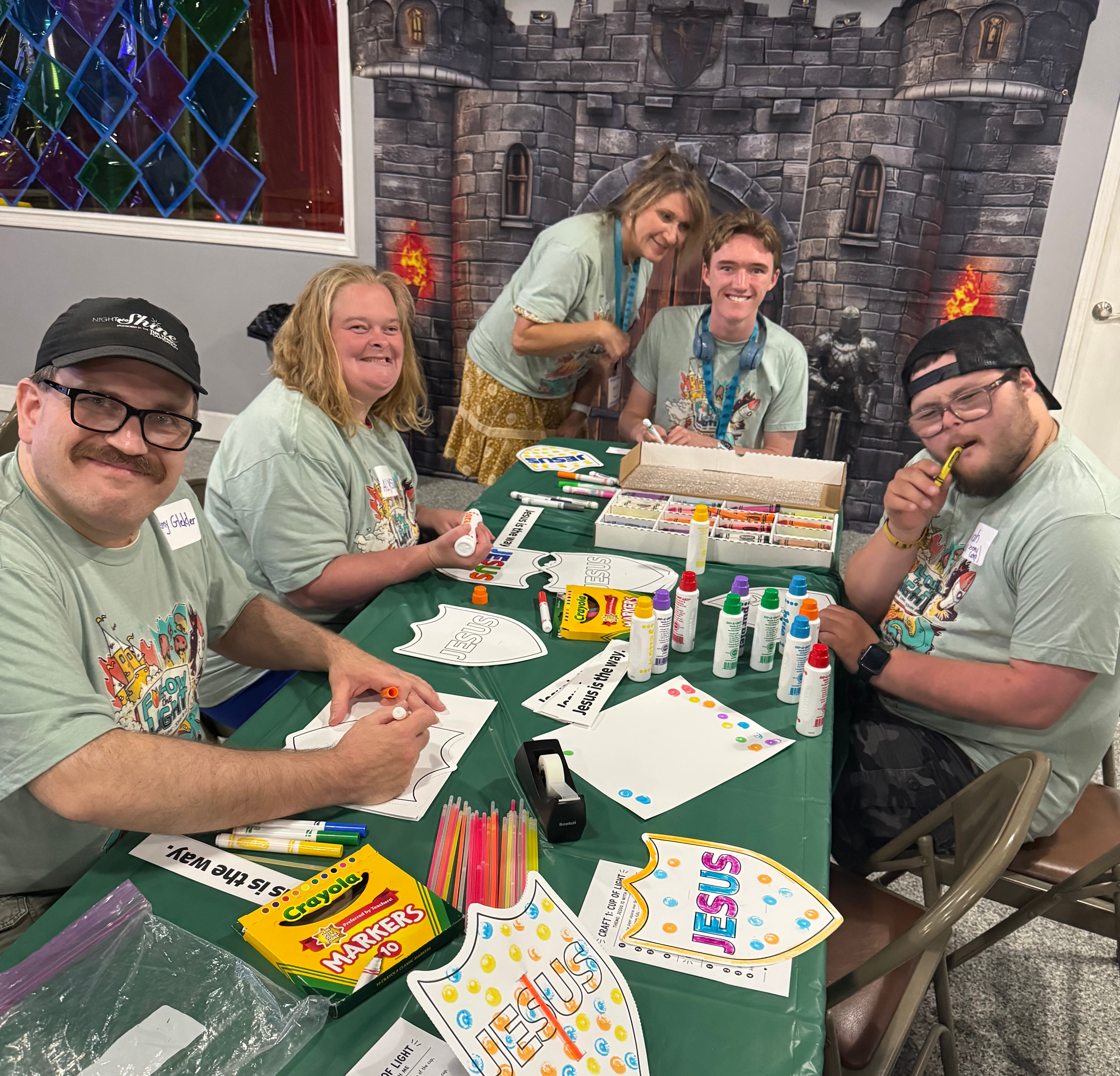 Smiling adults sitting together at a table.