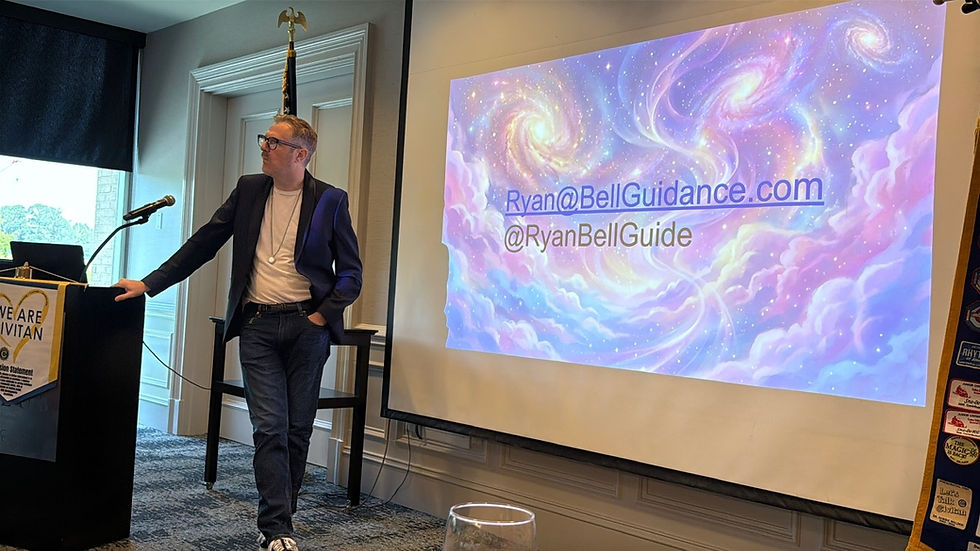 Presentation screen displaying a colorful nebula graphic with Ryan Bell's contact information, set up for a speaking engagement