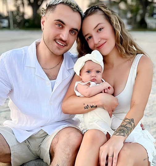Happy family on beach with baby