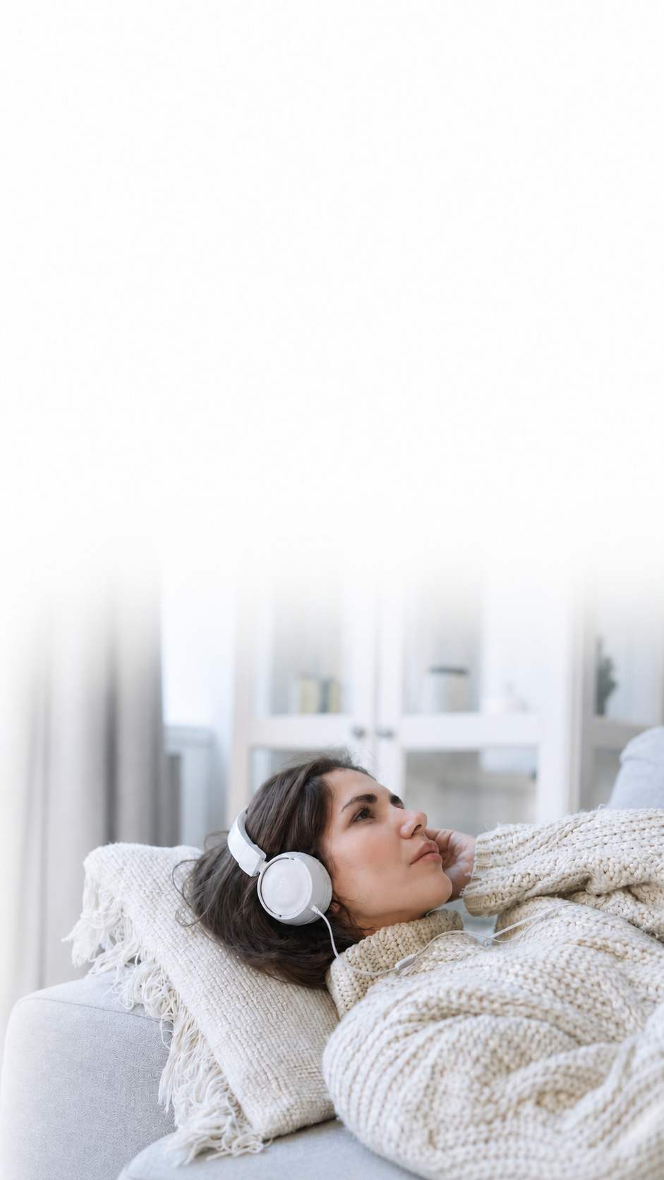 Reclining woman with white headphones.png