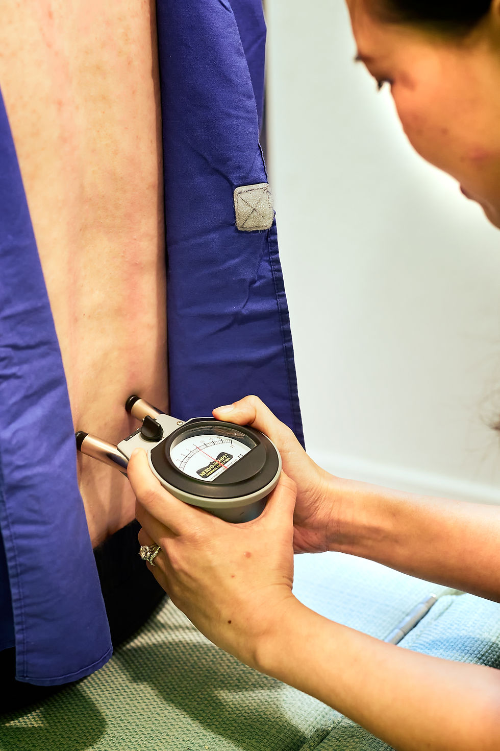 Eye-level view of chiropractic adjustment table with spine model