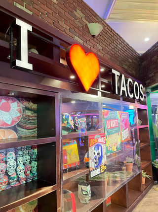 Lighted sign that reads I love tacos