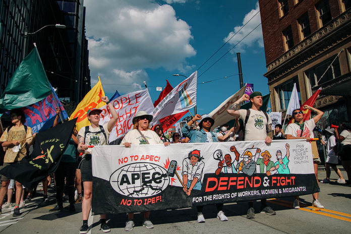 Marchers bearing the banner that says, "No to APEC, No to IPEF! Defend & Fight for the rights of workers, women and migrants"