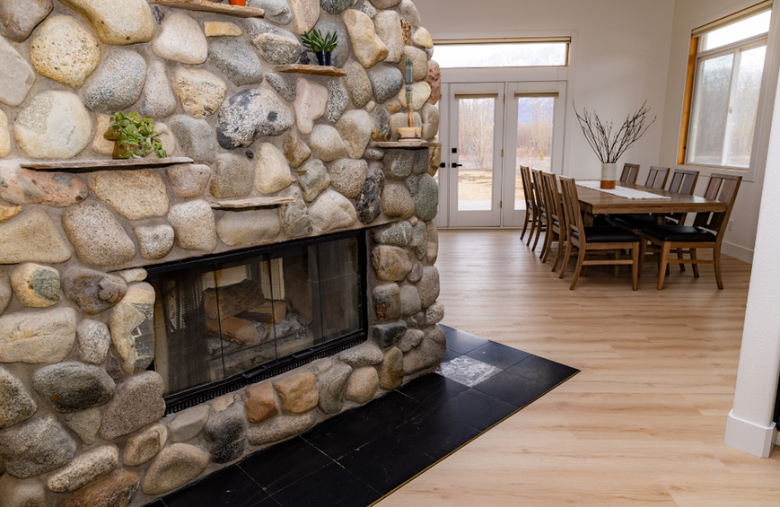 dining room and fireplace at the crown mountain house a private vacation rental in alaska