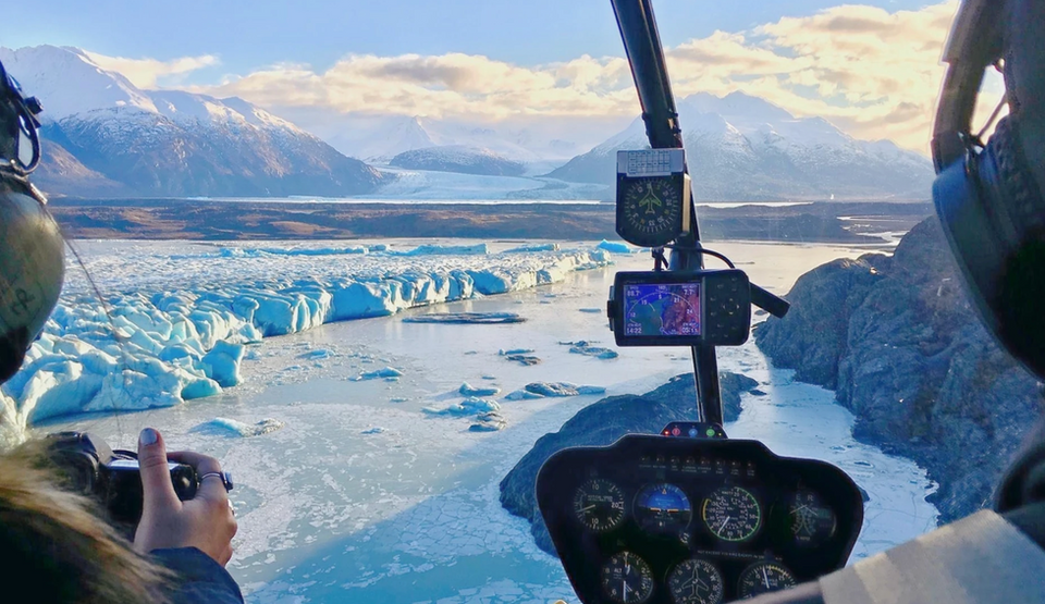 looking out from the pit of an alaska helicopter ride out towards mountains and glaciers
