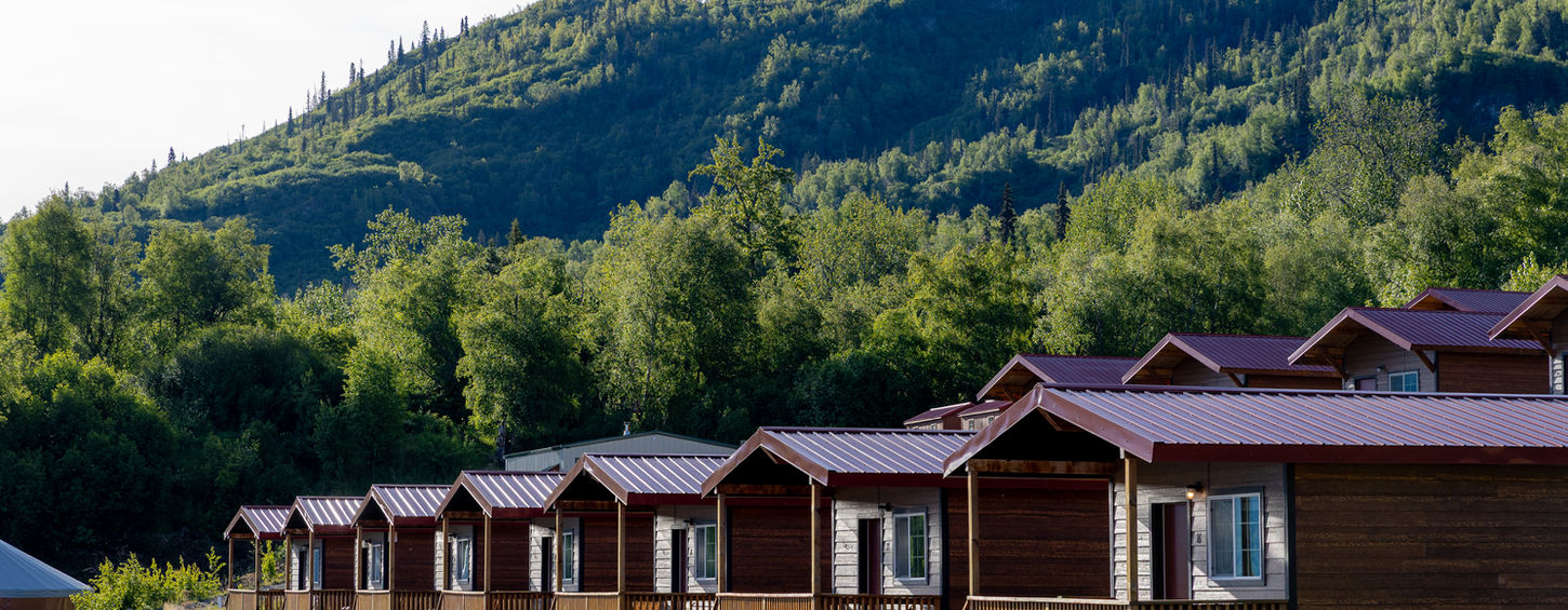 alaska cabins with tall mountains in the background