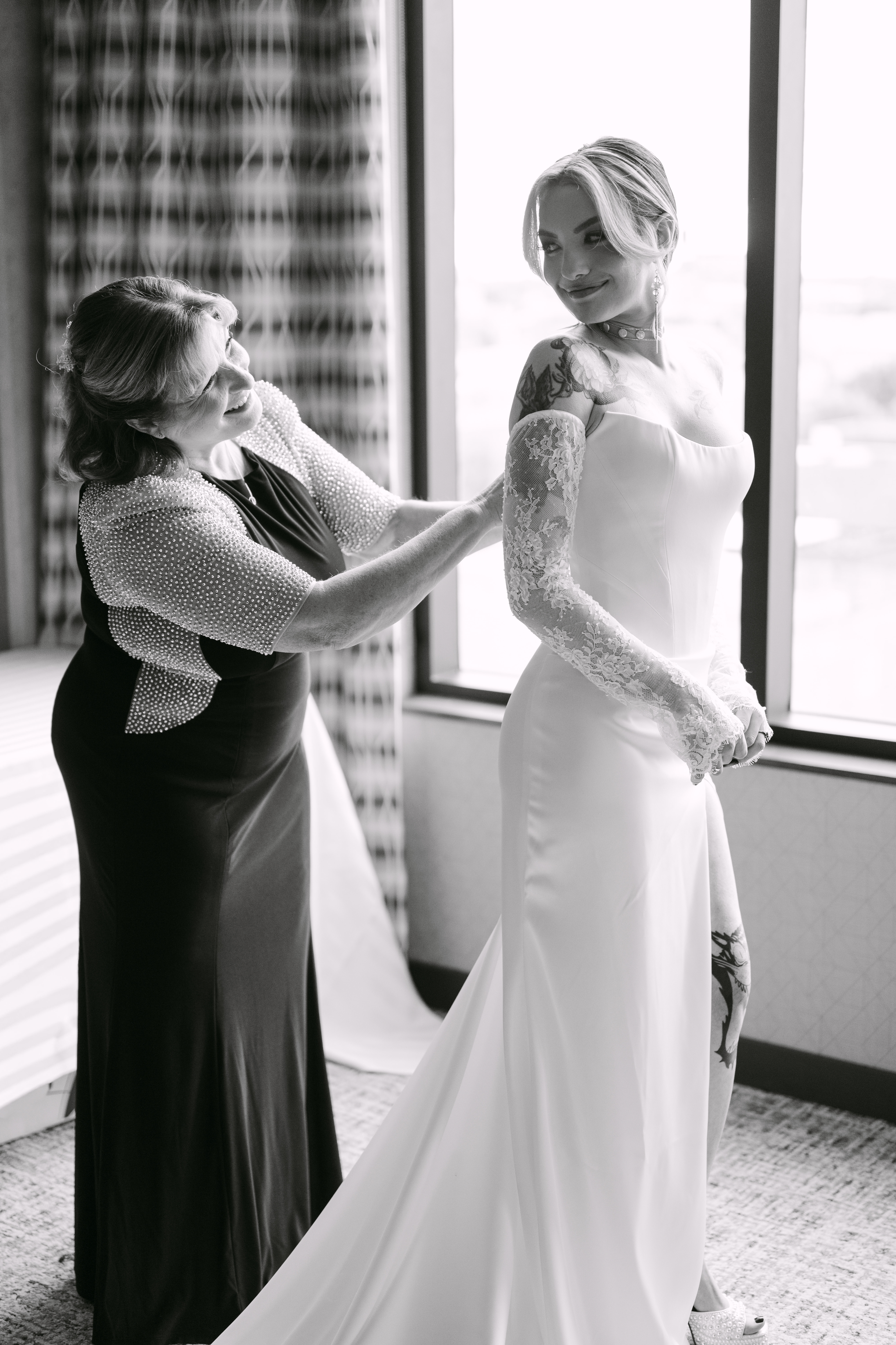 A brides mother helping with her wedding dress on her wedding day in chicago