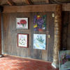 Lana Repina's artwork displayed during an exhibition at Waterfront Playa Alicia Restaurant in Sosúa, Dominican Republic