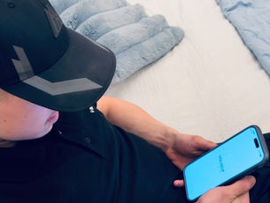 boy looking down at phone