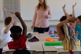 schoolboy-raising-their-hands-in-an-elem