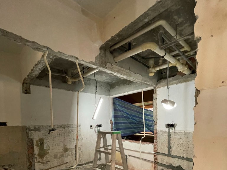 Exposed ceiling and plumbing services during refurbishment of older apartment