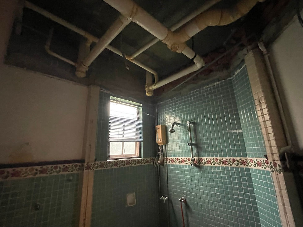 Existing bathroom stripped for plumbing and wet works during apartment renovation