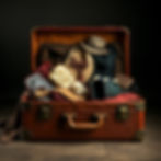 an actors suitcase, brown and old, open and overflowing with costumes.jpg