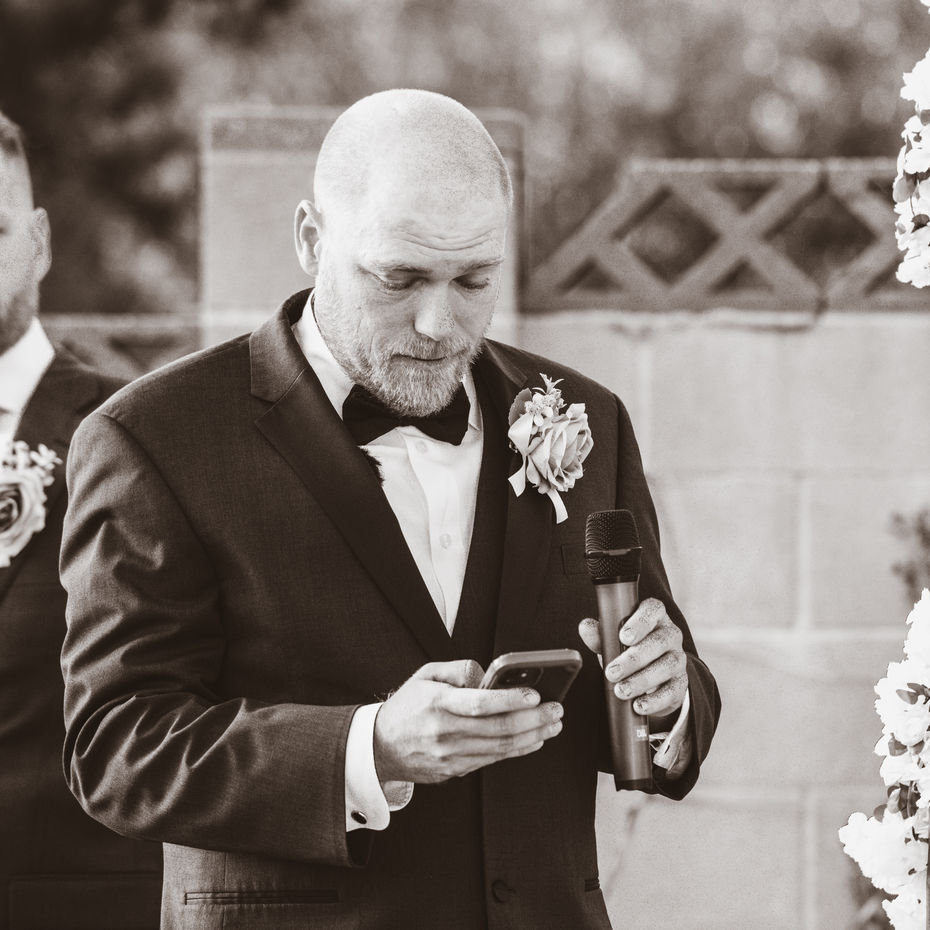 Groom reading vows to the bride at a backyard wedding 