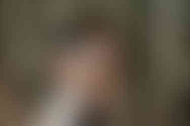 guy hugging a girl from behind during engagement shoot by the bamboos