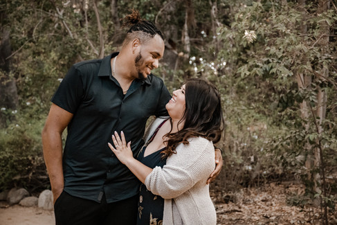 guy has his arms around the girl