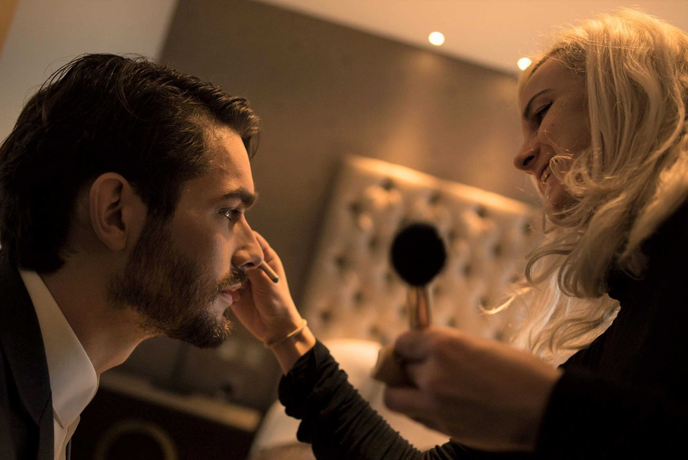 Make up artist worjking with a male model on a photo shoot production, Monte Carlo, UK