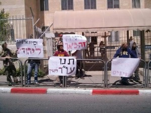 Protestors holding signs demanding the right to see an attorney