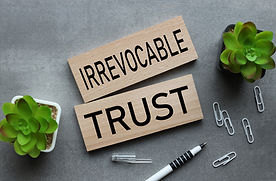 Irrevocable trust two wooden blocks on a gray background. text on wood.jpg