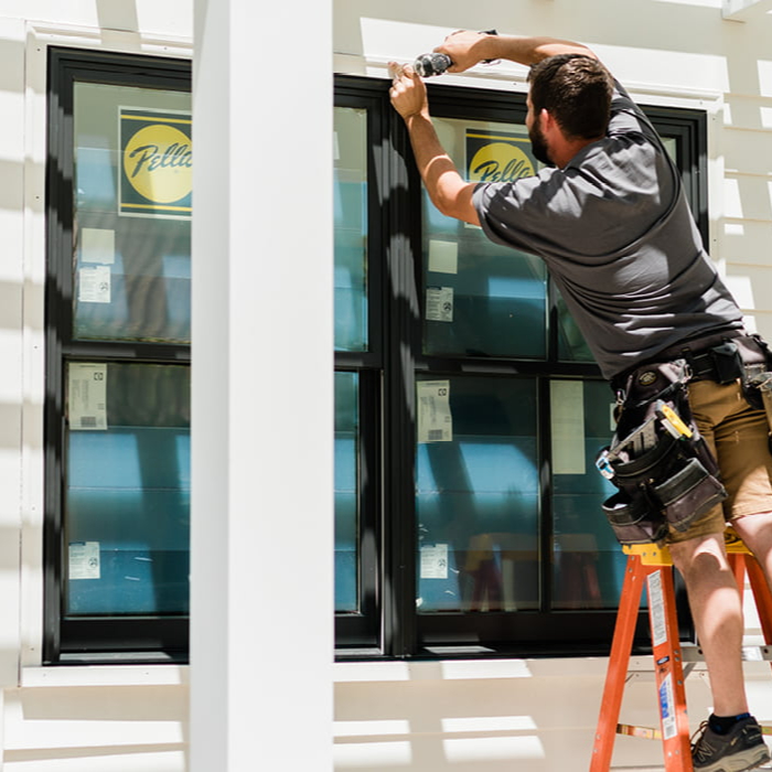 Window installer working at an opening