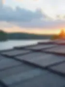 Close-up of asphalt shingle roof at sunset — Lakeside Exteriors roof replacement service in Minnesota