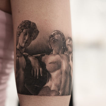 a realism tattoo of 3 statues of a woman