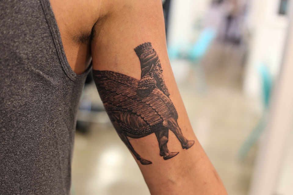 black and grey realism tattoo of Syrrian diety called lamma for a cover up.