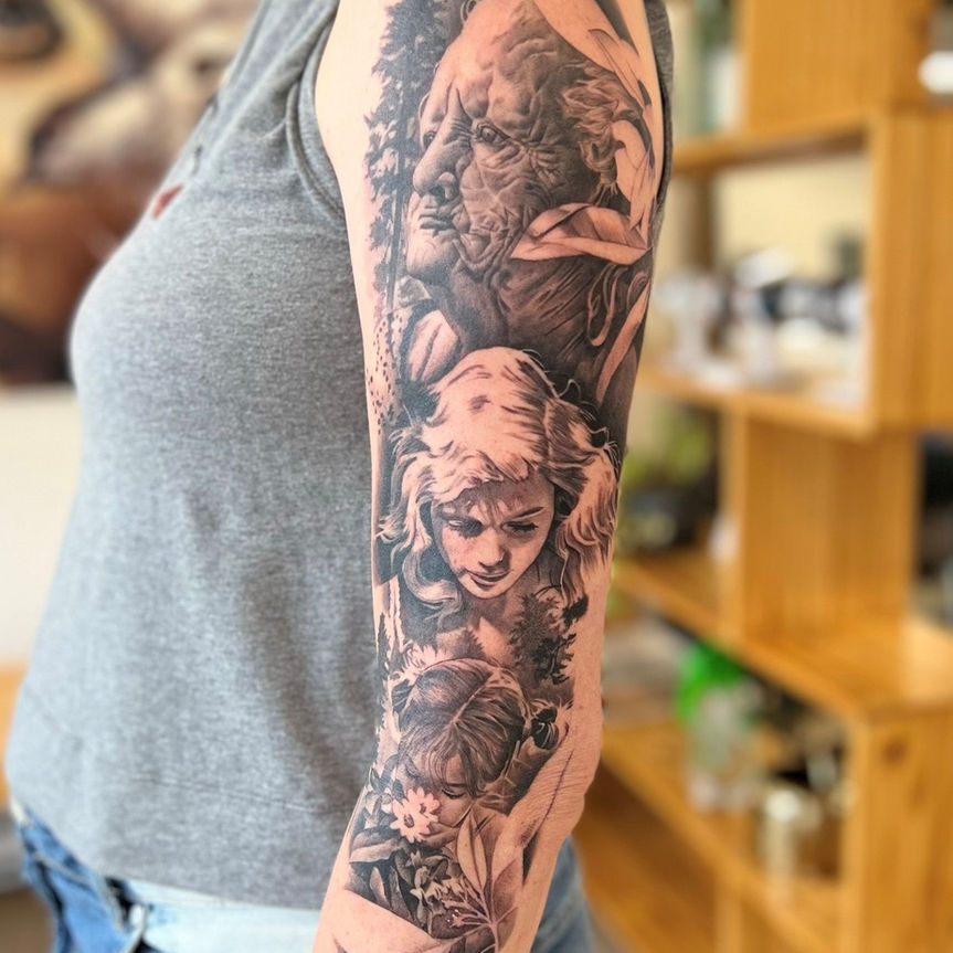tattoo of 3 portraits on the arm