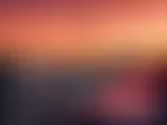 A wide-angle landscape photograph at sunset showing four diverse professionals in business attire standing on a modern glass balcony. They are holding laptops and tablets, smiling and conversing. In the background is the expansive Dubai skyline, featuring the Burj Khalifa towering over other skyscrapers under an orange and purple sky. Large text overlaid at the bottom right reads: "15,000+ AED Monthly".