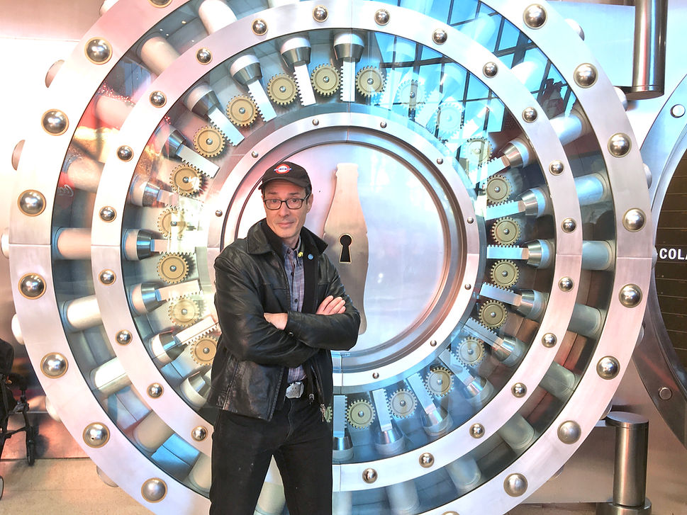 Joel Alpert in front of large safe door, inviting reader to click and explore the secrets behind our innovative strategic thinking