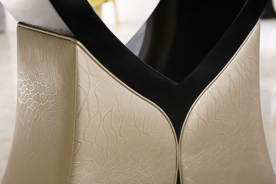 Elegante goldene Schranktüren mit geprägtem Muster und schwarzem Akzent.