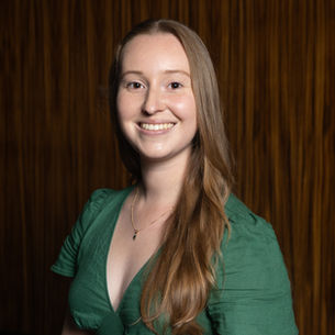 Young woman smiling at the camera in a green dress