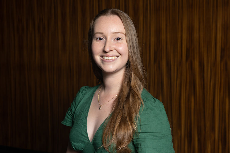 Young woman smiling at the camera in a green dress