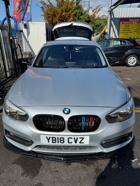 Close-up of silver BMW. Front