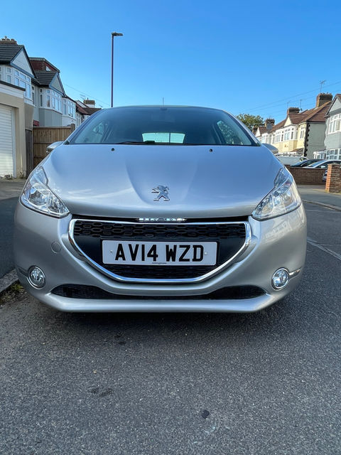 Silver Peugeot parked on the side of the road
