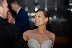Candid shot of a bride smiling during her wedding reception, unscripted photography in Windsor.