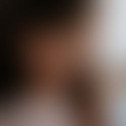 Woman standing alone looking down, quietly disappearing into a pattern of chronic submission