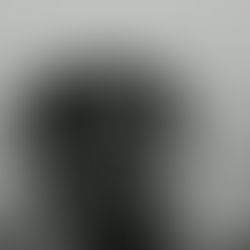 Man sitting alone with head in hands, overwhelmed by deep emotional pain