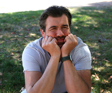 Steffen smiling, deep in thought outdoors